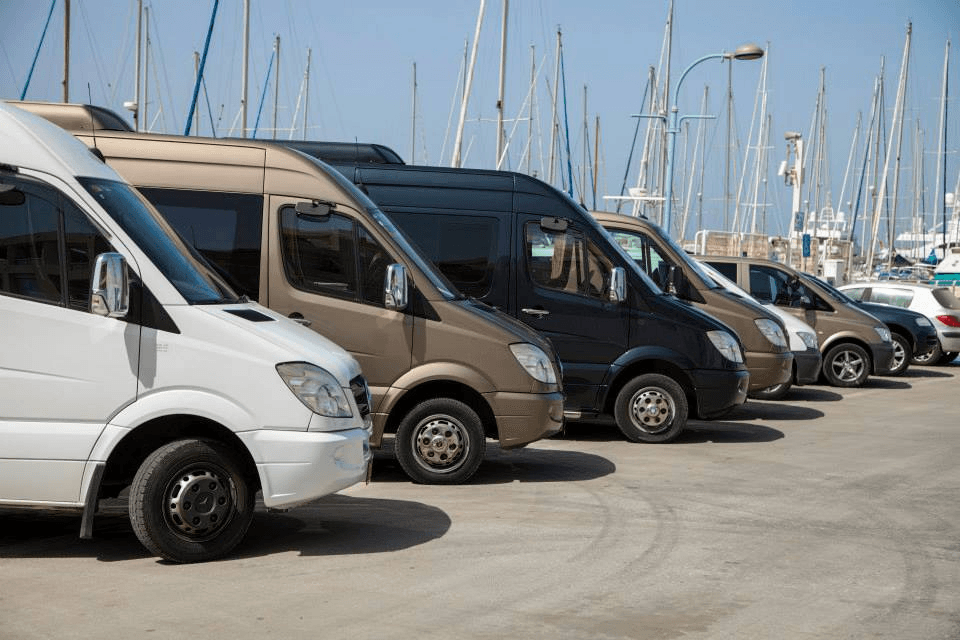 Mercedes-Benz Sprinter fleet lined up at a marina for luxury transfers in Israel